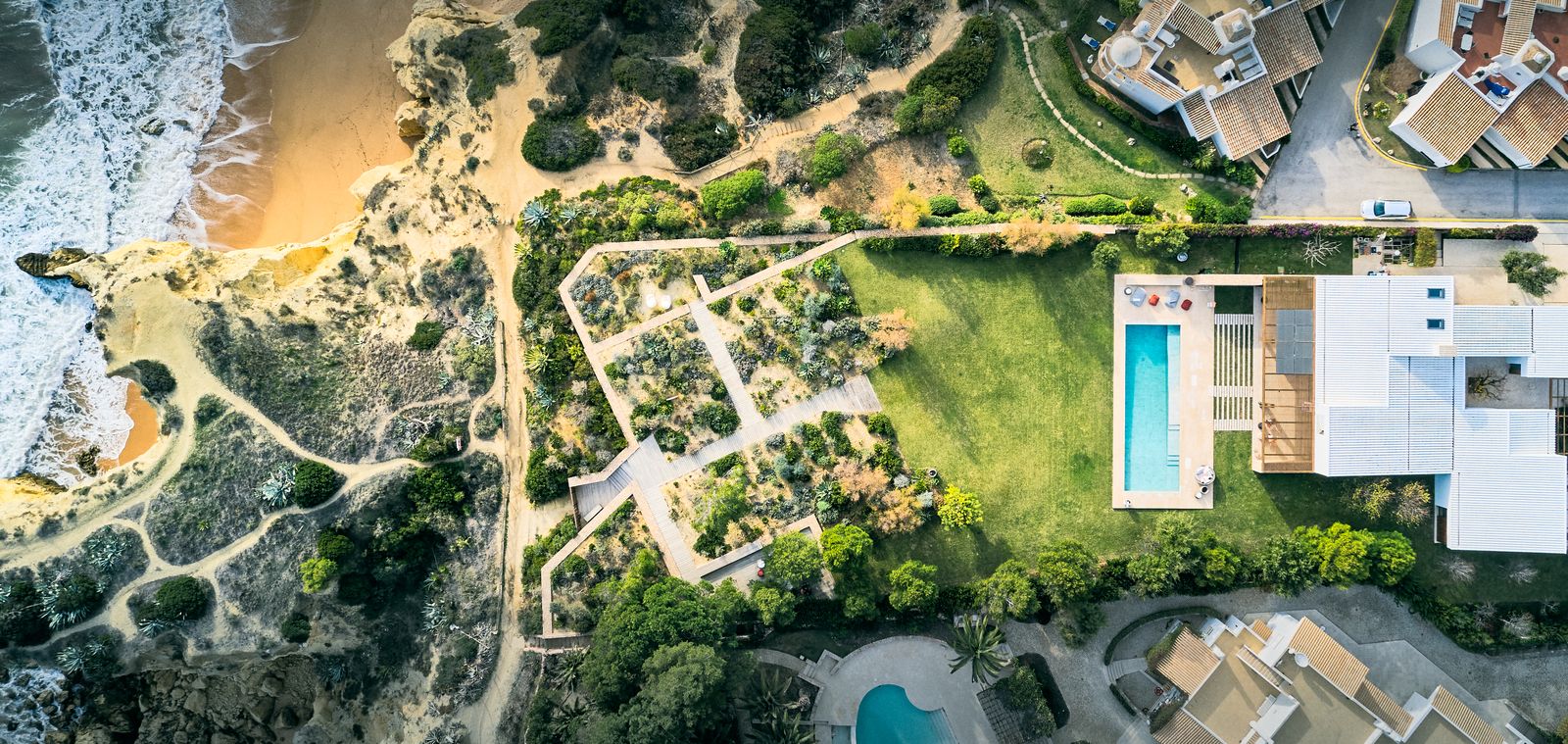 Aerial view of the villa, garden and beach